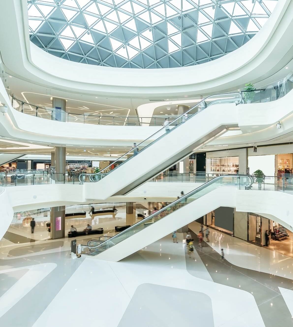 A large white building with escalators going up the side.